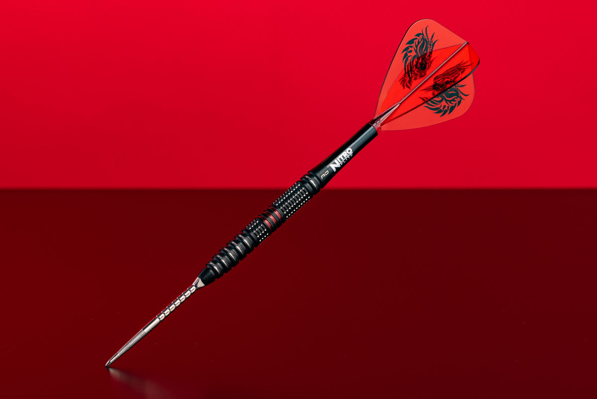 A single dart with a black textured barrel, silver needle point, and red flights featuring a black dragon logo, set against a split red and dark red background.
